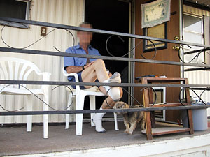 Man and his dog on a trailer porch