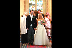 Married couple standing at the alter