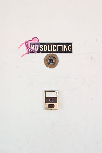 A door sign which has been altered to say 'I love soliciting'