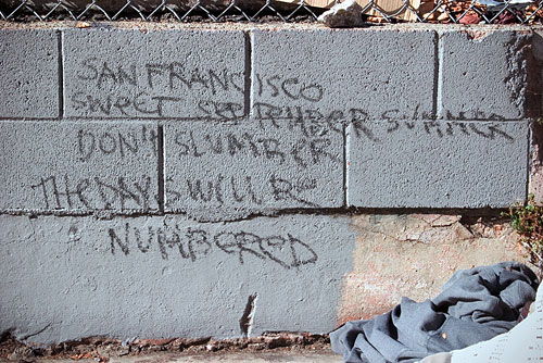 A poem written on a wall reading 'San Francisco, Sweet September summer, Don't slumber, The days will be numbered.'